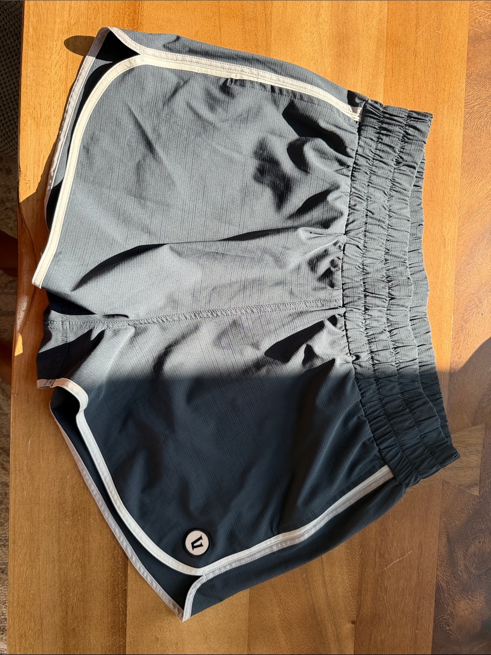Vuori Women's Athletic Shorts in Charcoal with White Trim
